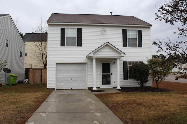 view of front of house with a front yard and a garage