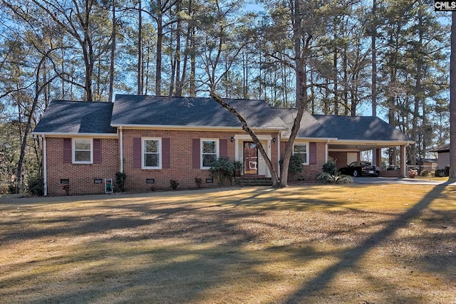 ranch-style house featuring a carport and a front lawn