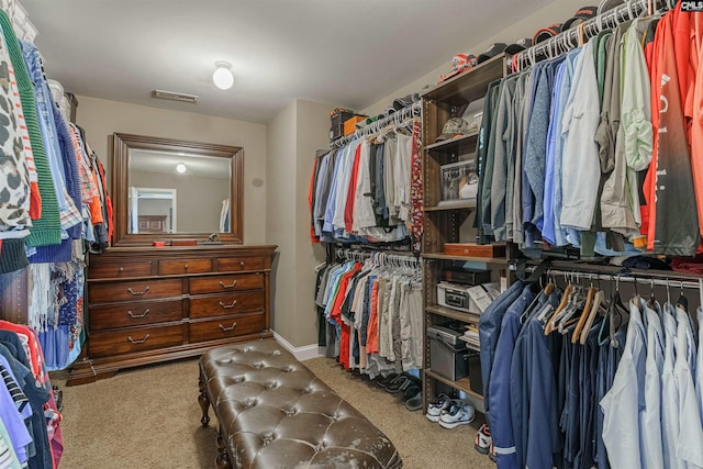 walk in closet with carpet flooring