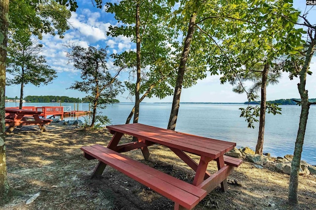 view of property's community featuring a water view and a boat dock