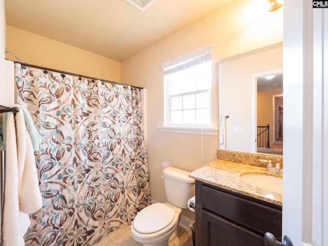 bathroom featuring toilet, tile floors, and large vanity