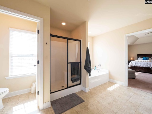 bathroom featuring shower with separate bathtub, tile floors, and toilet