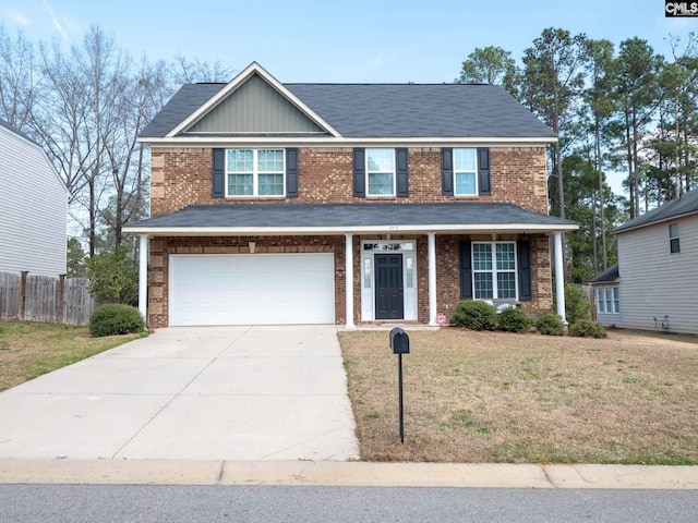 view of front of property with a front yard and a garage