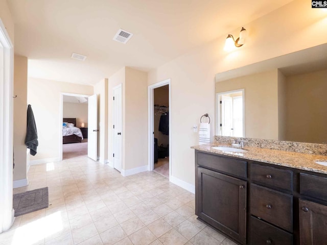 bathroom with dual sinks, oversized vanity, and tile flooring