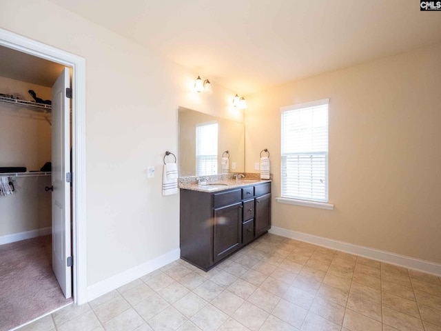 bathroom featuring tile floors and dual vanity