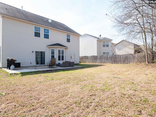 back of house with a yard and a patio area