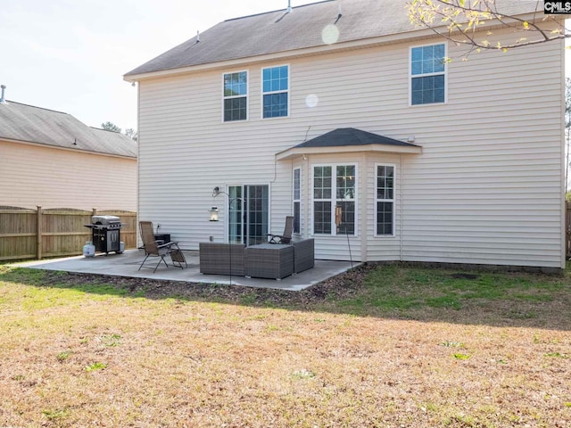 rear view of property featuring outdoor lounge area, a patio, and a yard