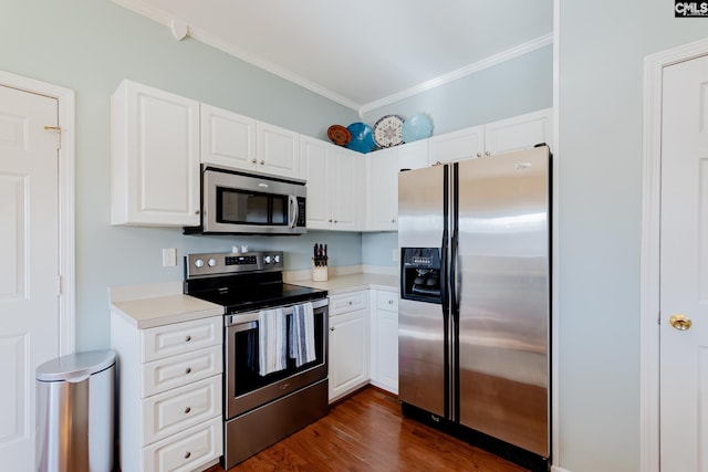 kitchen with white cabinets, appliances with stainless steel finishes, and dark hardwood / wood-style flooring