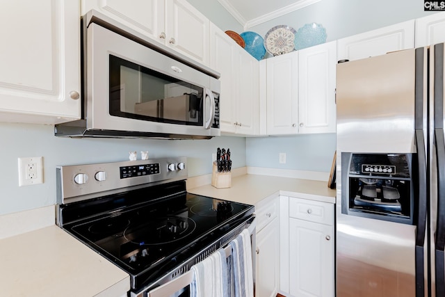 kitchen with appliances with stainless steel finishes, crown molding, and white cabinetry