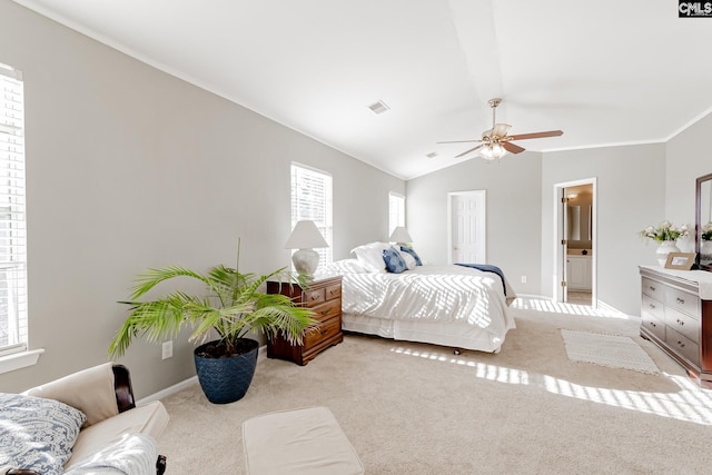 carpeted bedroom featuring connected bathroom, ornamental molding, ceiling fan, and lofted ceiling