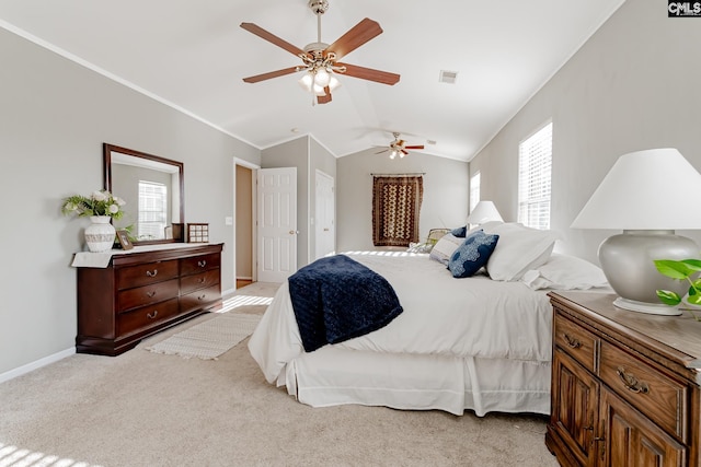 carpeted bedroom featuring crown molding, vaulted ceiling, ceiling fan, and multiple windows