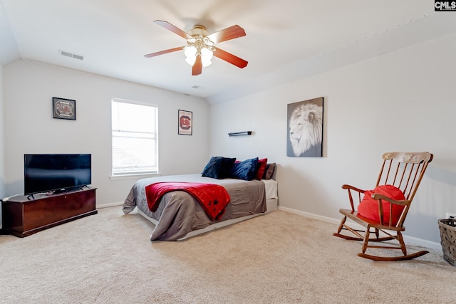 carpeted bedroom with ceiling fan and vaulted ceiling