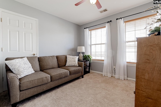 carpeted living room with ceiling fan