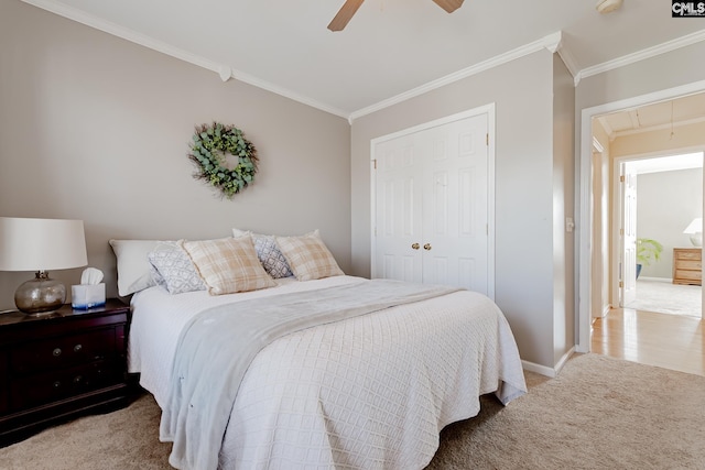 bedroom with light carpet, crown molding, a closet, and ceiling fan