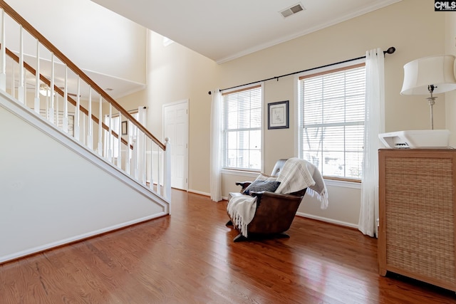 sitting room with crown molding and dark hardwood / wood-style flooring