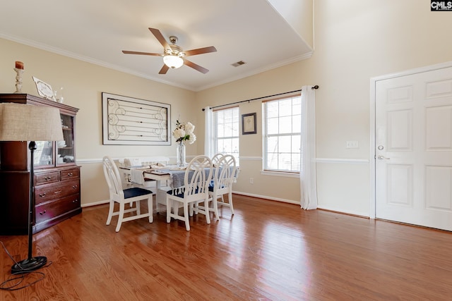 dining space with dark hardwood / wood-style floors, ceiling fan, and ornamental molding