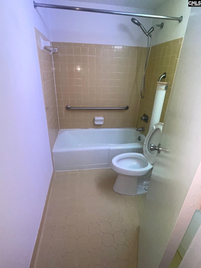 bathroom with toilet, tiled shower / bath, and tile flooring