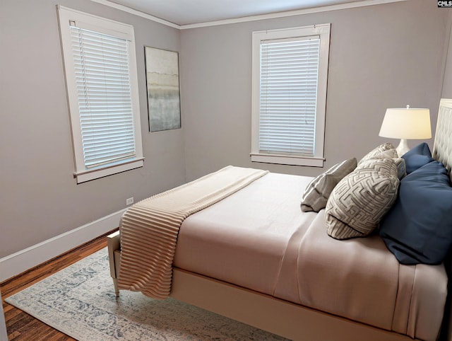 bedroom with crown molding and hardwood / wood-style flooring