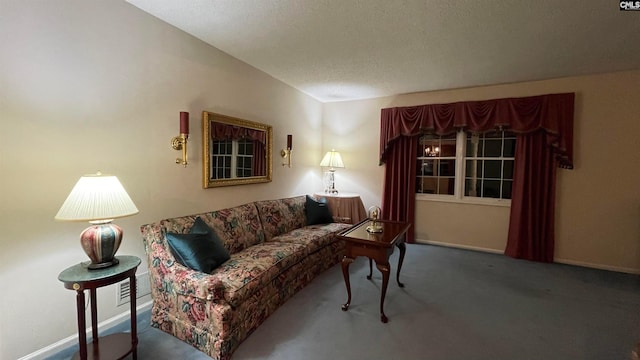 living room featuring a textured ceiling and dark colored carpet