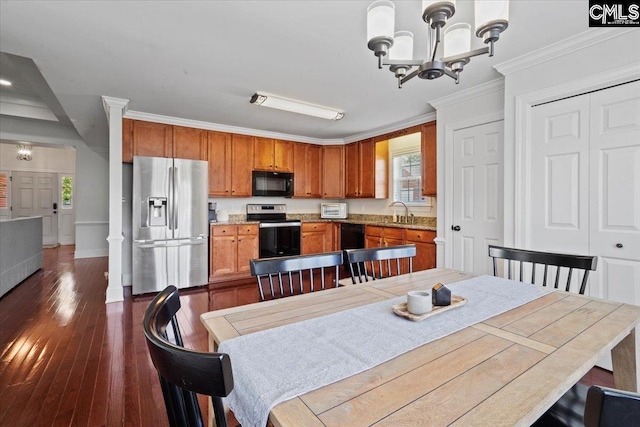 51 Swallowtail Ct, Columbia, SC 29229 - dining room featuring an inviting chandelier, sink, ornamental molding, dark hardwood / wood-style floors, and ornate columns