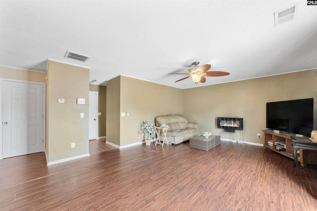 sitting room with ceiling fan and dark hardwood / wood-style flooring