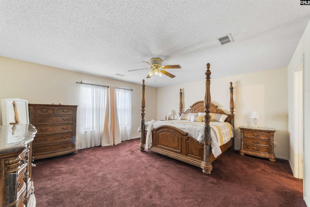 carpeted bedroom with ceiling fan and a textured ceiling