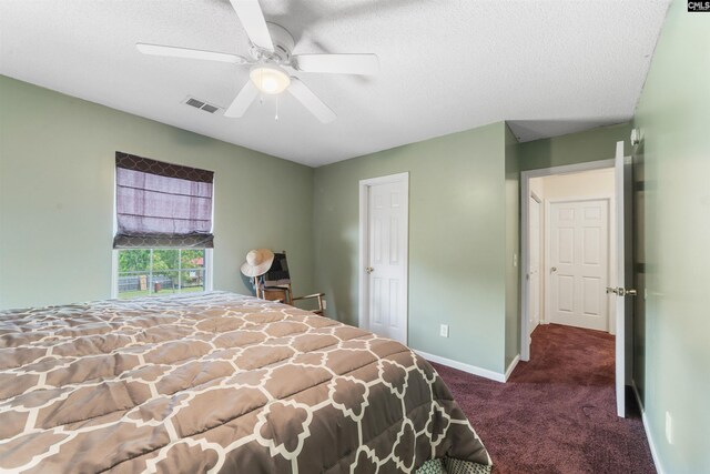 carpeted bedroom featuring a textured ceiling and ceiling fan