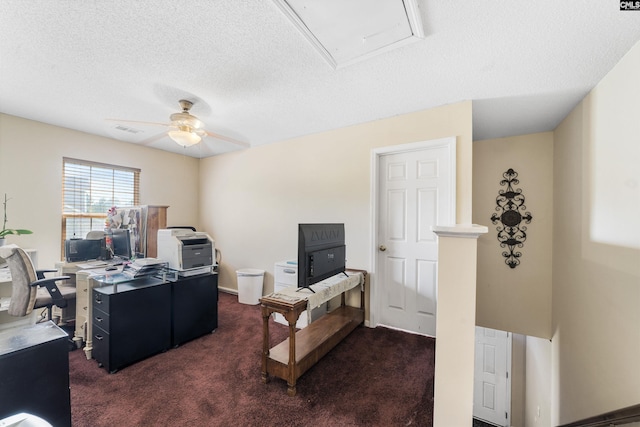 carpeted office with a textured ceiling and ceiling fan