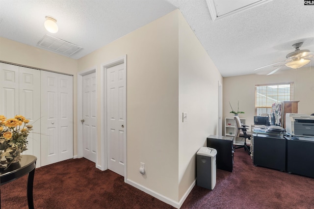 carpeted office with ceiling fan and a textured ceiling