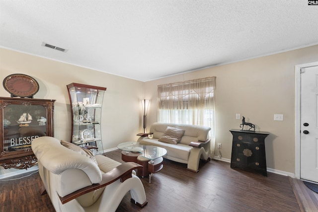 living room featuring a textured ceiling and dark hardwood / wood-style floors