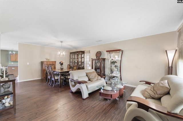 living room featuring a notable chandelier and dark wood-type flooring