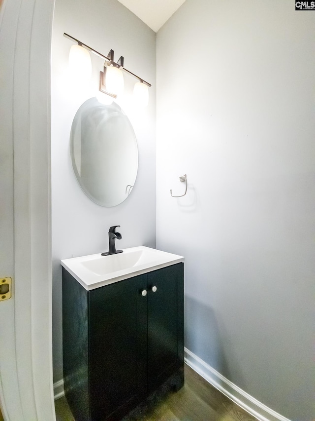 bathroom with vanity and hardwood / wood-style flooring