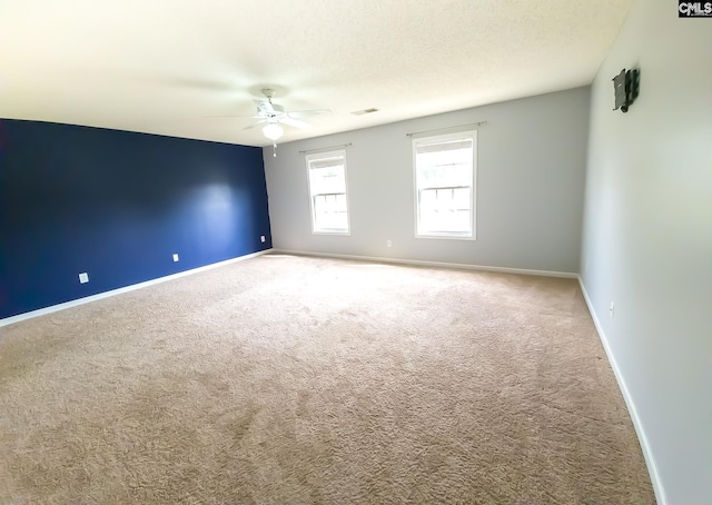 carpeted empty room with a textured ceiling and ceiling fan