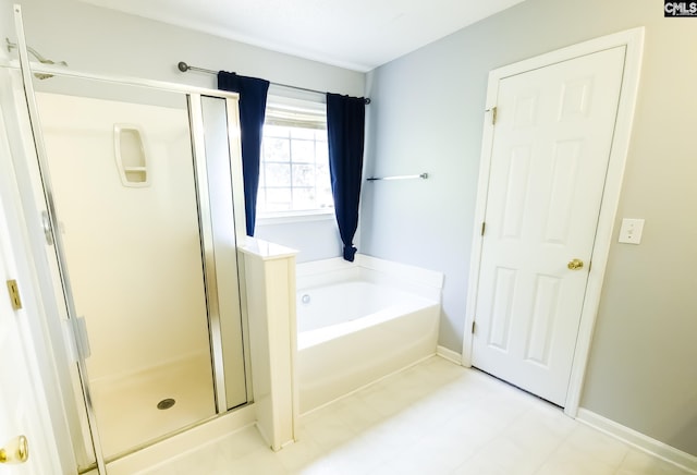 bathroom with shower with separate bathtub and tile floors