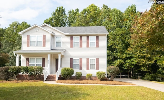 view of front of home featuring covered porch and a front yard