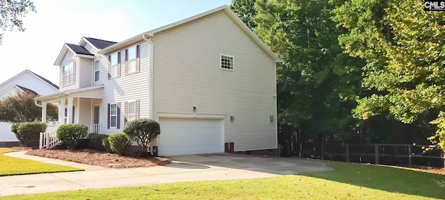 view of home's exterior with covered porch and a garage