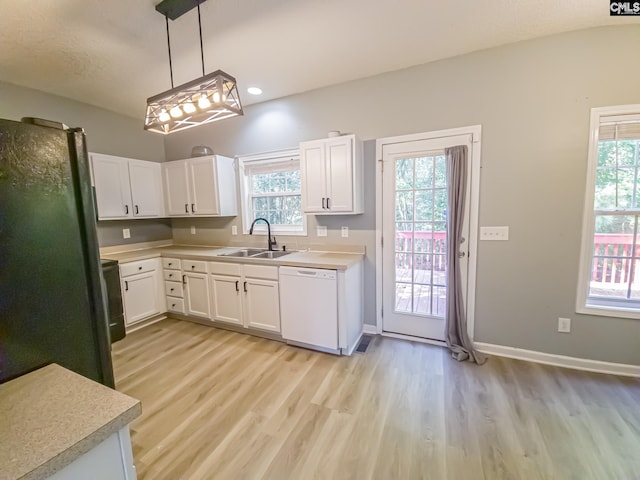 kitchen featuring pendant lighting, sink, white cabinets, light hardwood / wood-style flooring, and dishwasher