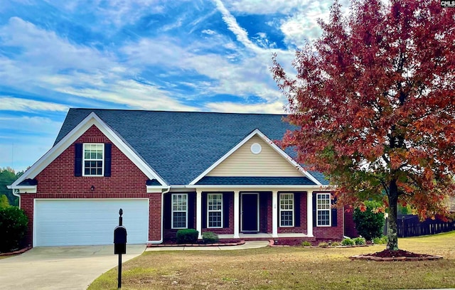 view of front of home with a front yard and a garage