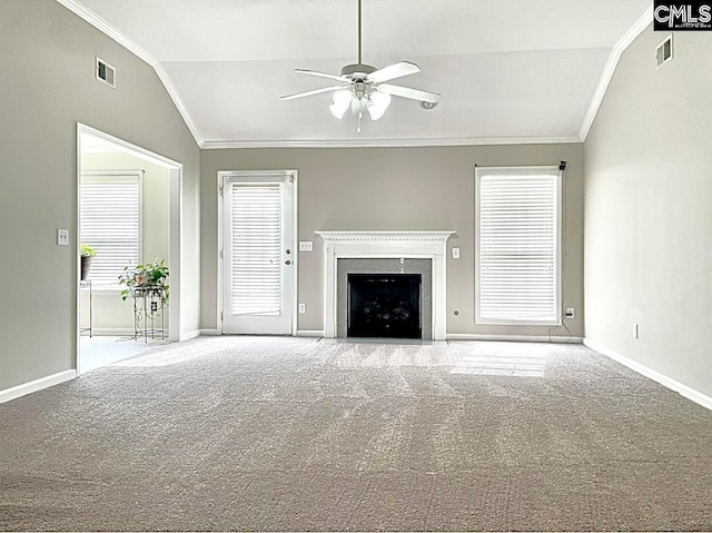 unfurnished living room featuring light colored carpet, lofted ceiling, ceiling fan, and ornamental molding