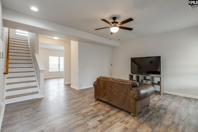 living room featuring hardwood / wood-style floors and ceiling fan