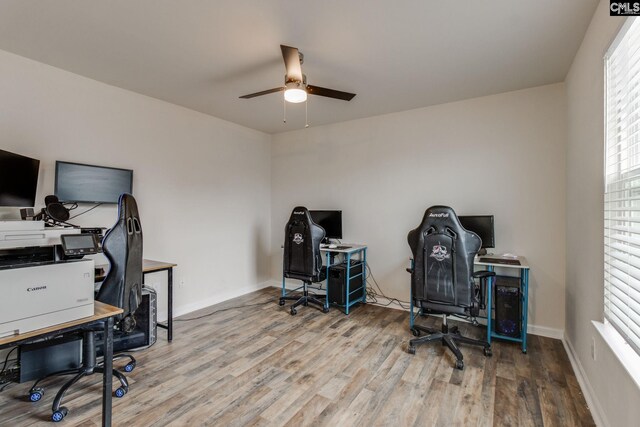 office with ceiling fan and light hardwood / wood-style flooring