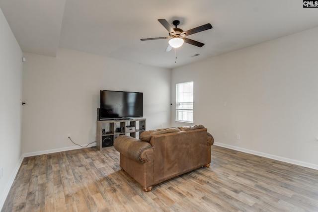 living room with ceiling fan and light wood-type flooring