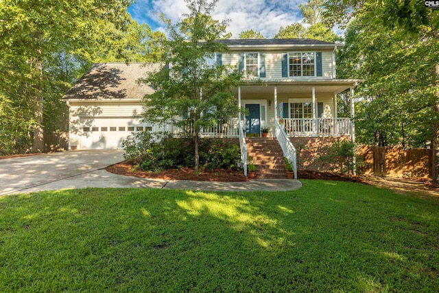 colonial home with a porch, a front lawn, and a garage