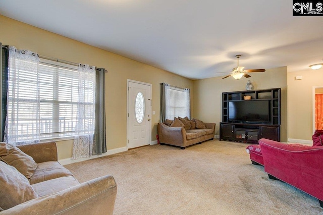 carpeted living room with ceiling fan