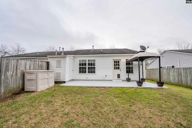 rear view of house with a yard and a patio area