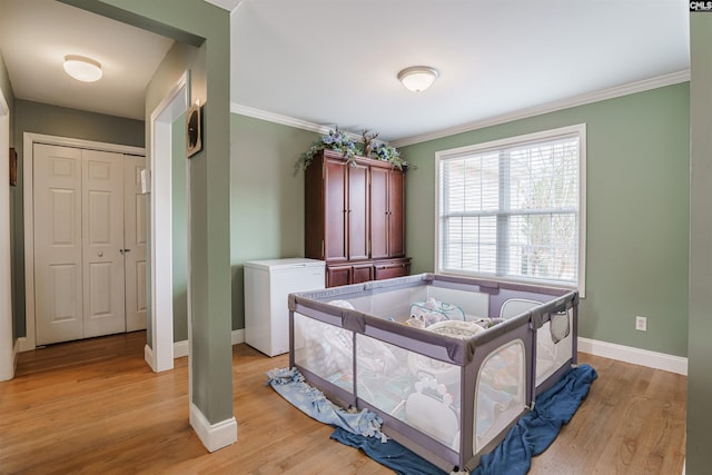 bedroom featuring crown molding, a closet, light wood-type flooring, and refrigerator