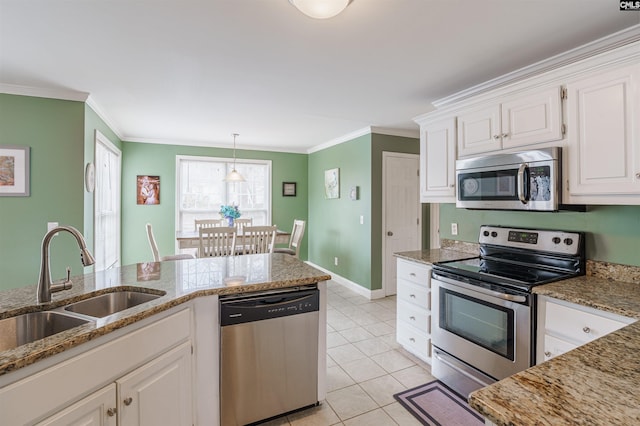 kitchen with light tile floors, appliances with stainless steel finishes, light stone countertops, decorative light fixtures, and white cabinetry