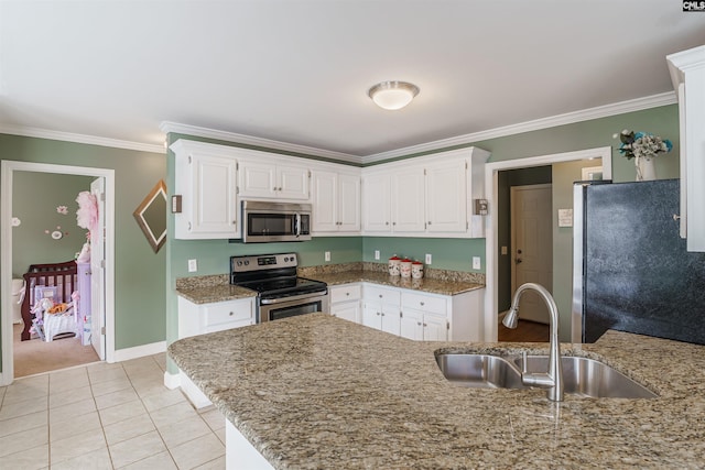 kitchen with light stone countertops, sink, stainless steel appliances, light tile floors, and white cabinets