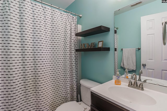 bathroom with toilet and vanity