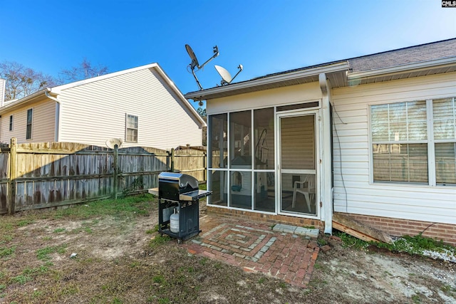 rear view of property with a sunroom